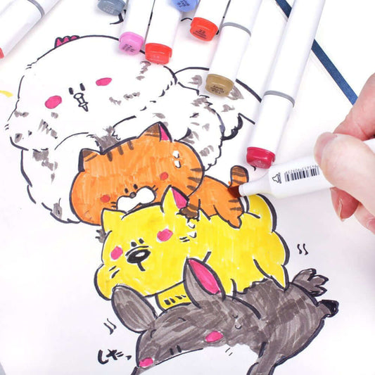 An artist using dual-tipped alcohol markers to color a cute drawing of stacked cartoon animals.